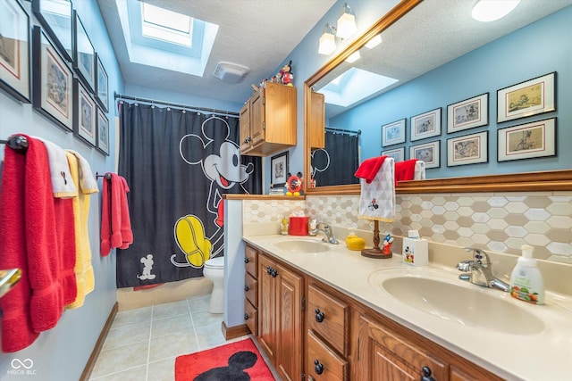 7020 N 375 E, Lebanon, IN 46052 - bathroom featuring a skylight, tasteful backsplash, and a sink