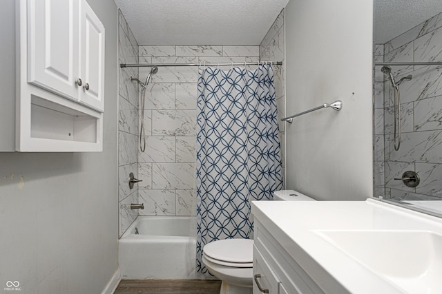 6814 Summer Time Dr, Indianapolis, IN 46226 - full bath featuring toilet, a textured ceiling, wood finished floors, and shower / bath combo with shower curtain