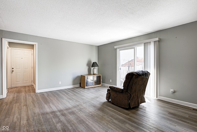 6814 Summer Time Dr, Indianapolis, IN 46226 - living area featuring a textured ceiling, baseboards, wood finished floors, and visible vents