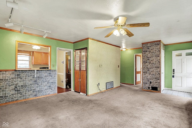 2307 Magnolia Pl, Indianapolis, IN 46219 - unfurnished living room with a ceiling fan, carpet flooring, crown molding, rail lighting, and baseboards