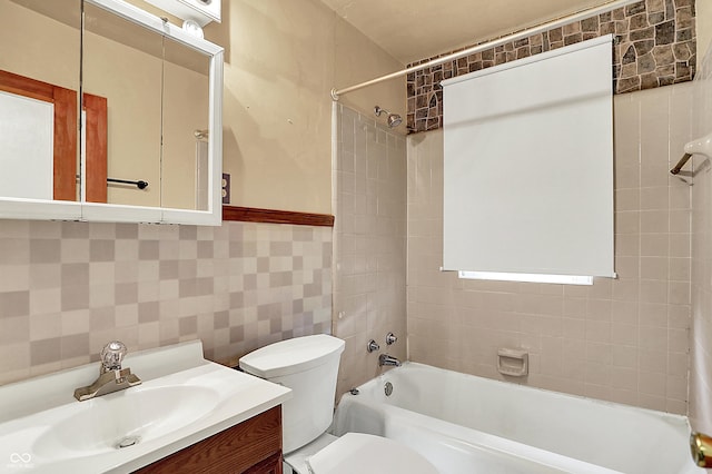 2307 Magnolia Pl, Indianapolis, IN 46219 - bathroom featuring tub / shower combination, tile walls, toilet, and vanity