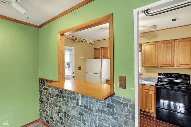 2307 Magnolia Pl, Indianapolis, IN 46219 - kitchen featuring electric range, freestanding refrigerator, dark tile patterned floors, and crown molding