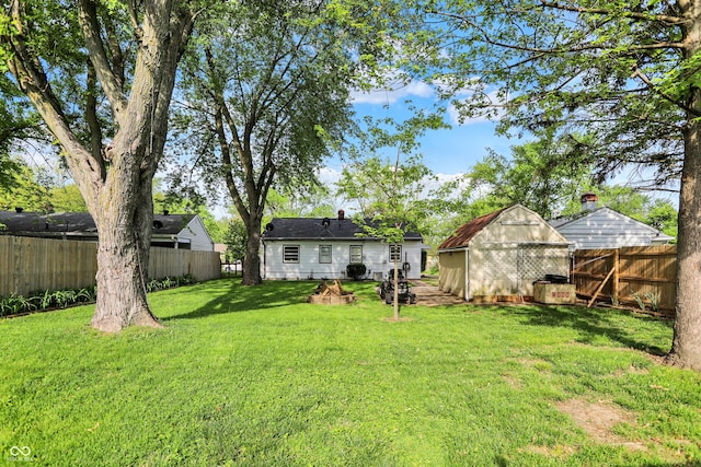 2307 Magnolia Pl, Indianapolis, IN 46219 - rear view of property featuring a storage unit, an outbuilding, and an outdoor fire pit