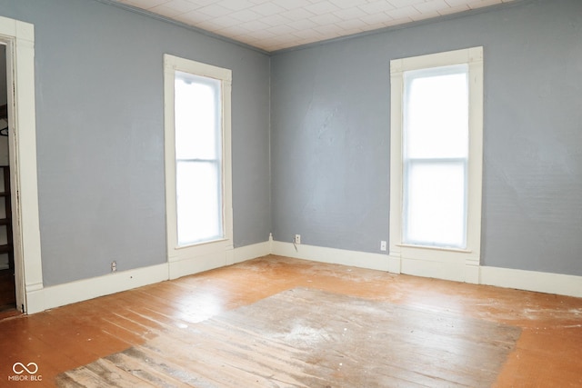 307 N Main St, Carthage, IN 46115 - spare room featuring healthy amount of natural light and hardwood / wood-style floors
