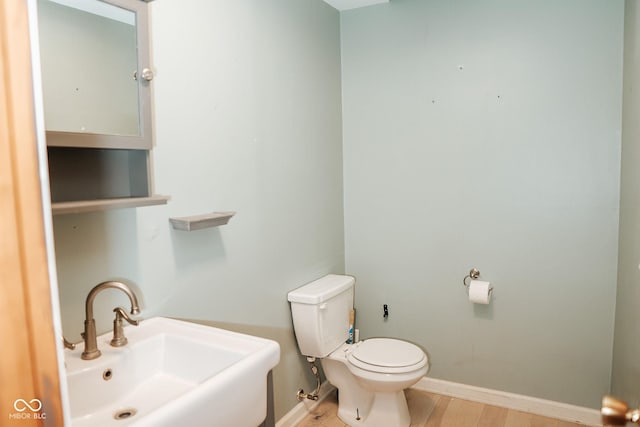 307 N Main St, Carthage, IN 46115 - bathroom with a sink and wood finished floors