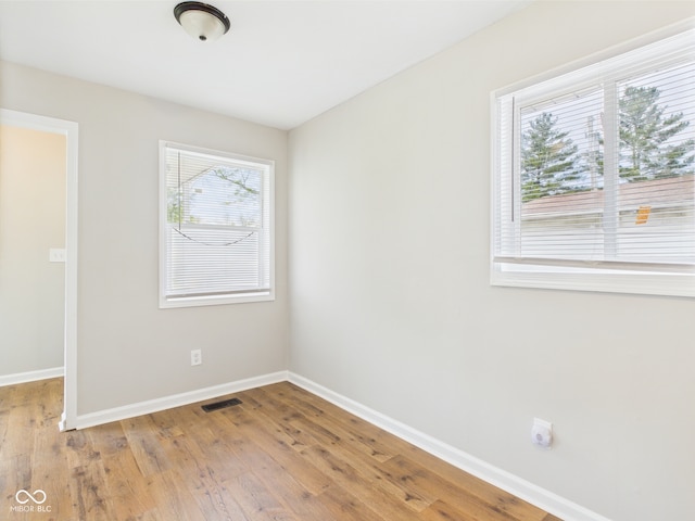979 Monroe St, Indianapolis, IN 46229 - unfurnished room featuring visible vents, baseboards, plenty of natural light, and wood finished floors