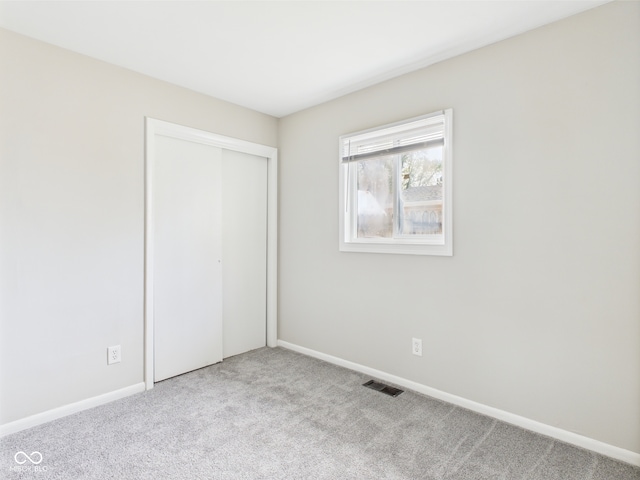 979 Monroe St, Indianapolis, IN 46229 - unfurnished bedroom featuring a closet, baseboards, carpet flooring, and visible vents