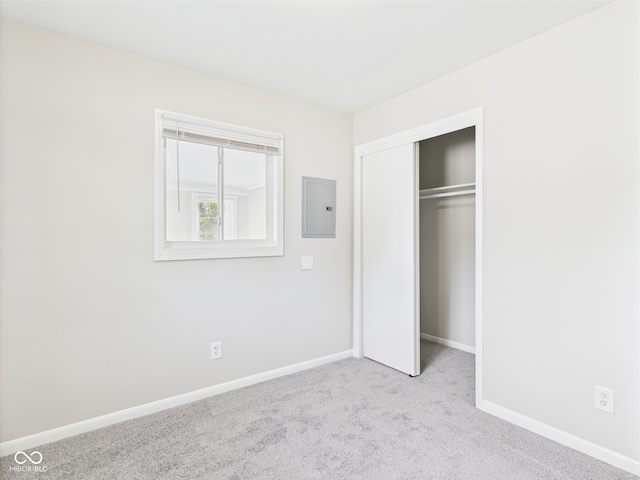 979 Monroe St, Indianapolis, IN 46229 - unfurnished bedroom featuring carpet, baseboards, electric panel, and a closet