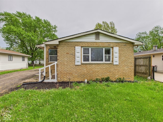 979 Monroe St, Indianapolis, IN 46229 - view of front of house with brick siding and a front yard