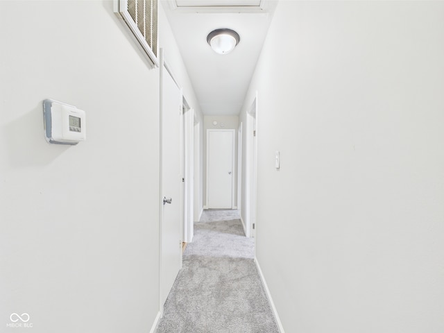 979 Monroe St, Indianapolis, IN 46229 - hallway featuring baseboards, visible vents, and light carpet