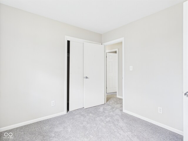 979 Monroe St, Indianapolis, IN 46229 - unfurnished bedroom with baseboards, carpet, and a closet