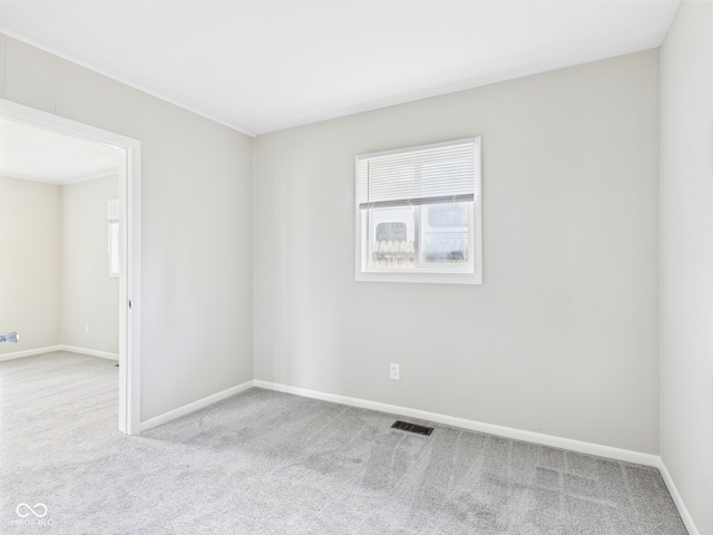 979 Monroe St, Indianapolis, IN 46229 - spare room featuring baseboards, a healthy amount of sunlight, and carpet