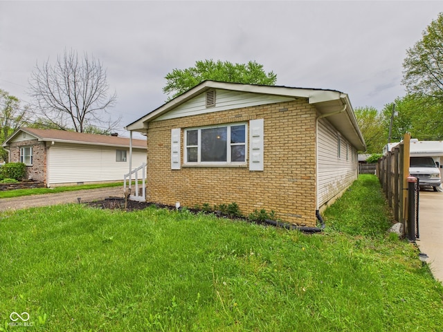 979 Monroe St, Indianapolis, IN 46229 - view of front of house with fence, a front yard, and brick siding