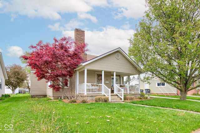 120 W S St, Tipton, IN 46072 - bungalow-style house featuring covered porch, a chimney, and a front yard
