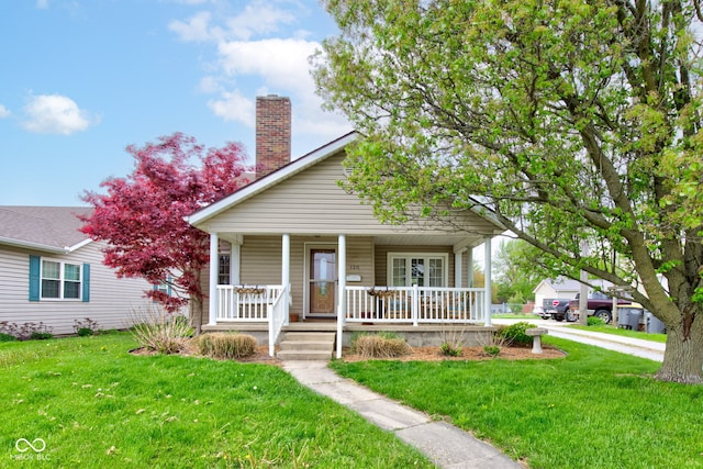 120 W S St, Tipton, IN 46072 - bungalow-style home with a porch, a chimney, and a front yard