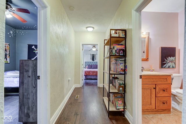 120 W S St, Tipton, IN 46072 - hallway featuring baseboards, a sink, and wood finished floors