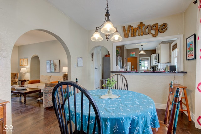 120 W S St, Tipton, IN 46072 - dining space with arched walkways, baseboards, and wood finished floors