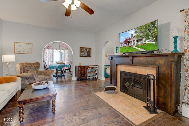 120 W S St, Tipton, IN 46072 - living room with a tiled fireplace, arched walkways, a ceiling fan, and wood finished floors