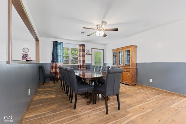dining space featuring baseboards, light wood-style flooring, and ceiling fan