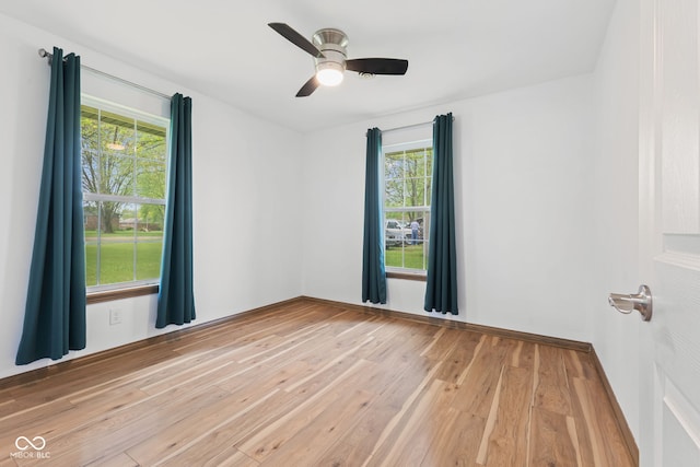 unfurnished room with a ceiling fan and light wood finished floors