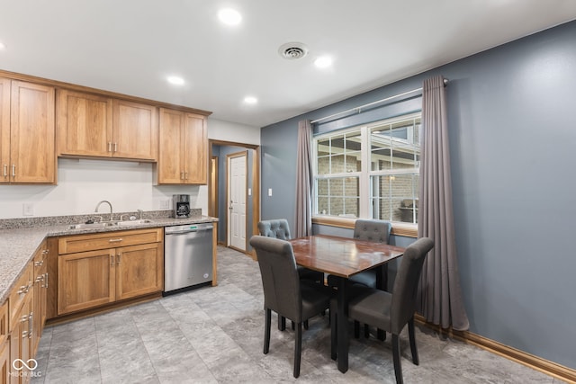 kitchen with a sink, brown cabinetry, light stone counters, recessed lighting, and dishwasher