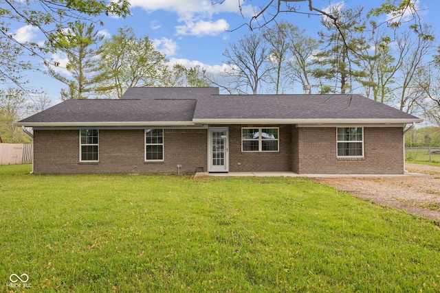single story home with fence, a patio, a front lawn, and brick siding