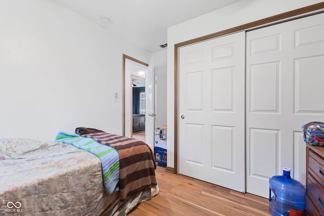 bedroom with a closet and light wood-type flooring