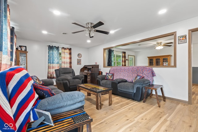 living area featuring light wood-style flooring, ceiling fan, and recessed lighting