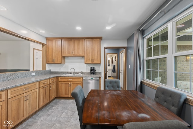 kitchen with a sink, brown cabinetry, stainless steel dishwasher, light stone counters, and recessed lighting