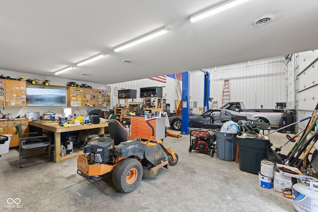 garage featuring a workshop area and visible vents