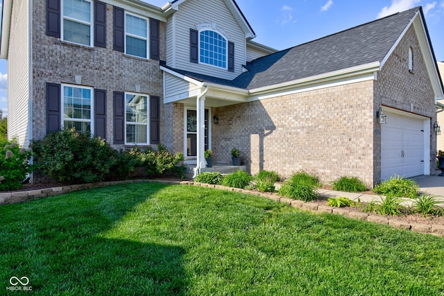 traditional-style home with brick siding, an attached garage, a front yard, driveway, and roof with shingles