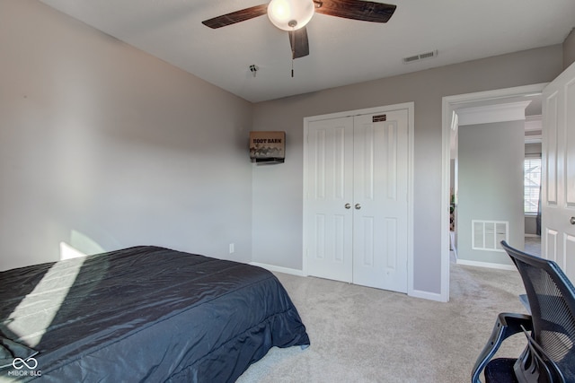 bedroom featuring a closet, carpet floors, baseboards, and ceiling fan