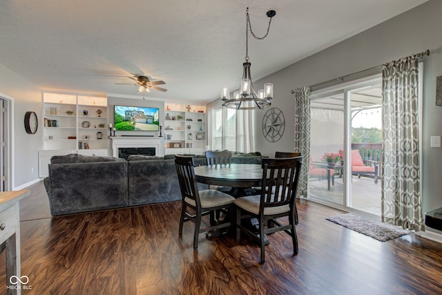 dining space featuring a fireplace, healthy amount of natural light, dark wood-style flooring, and ceiling fan