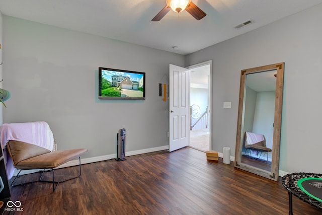 sitting room with dark wood-style flooring, ceiling fan, and baseboards