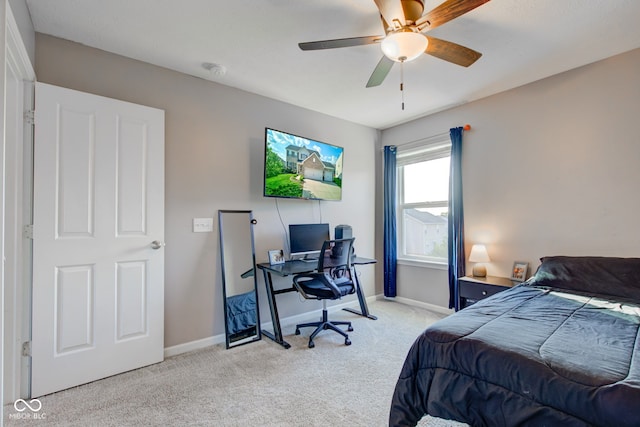 carpeted bedroom featuring baseboards, an office area, and ceiling fan