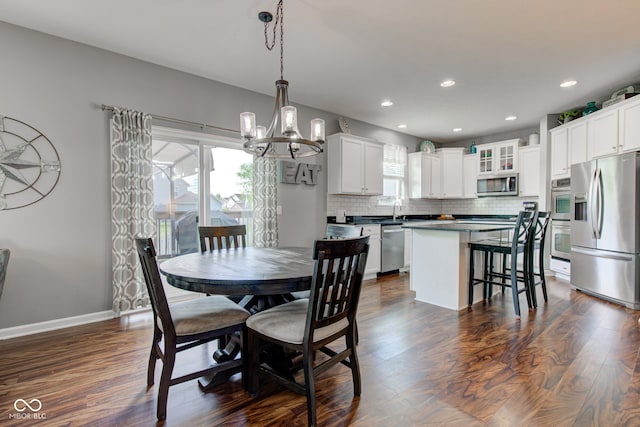 dining area with plenty of natural light, a chandelier, dark wood finished floors, and recessed lighting