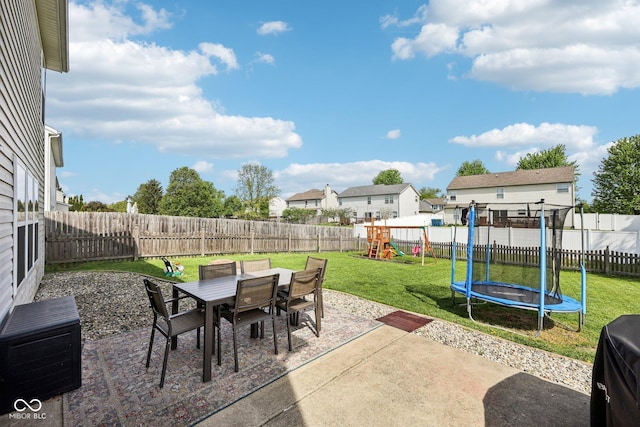 view of patio with a fenced backyard, a trampoline, a playground, and outdoor dining space