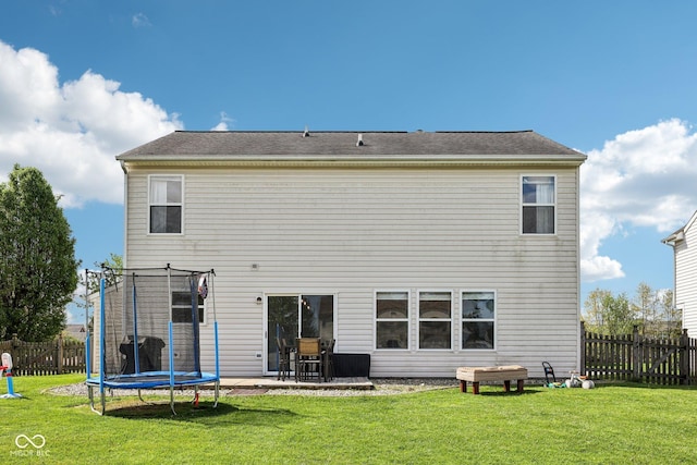 back of property with a fenced backyard, a trampoline, a patio area, and a yard