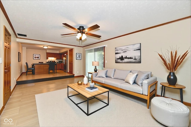 12087 N Gasburg Rd, Mooresville, IN 46158 - living area with light wood-style floors, ceiling fan, and crown molding