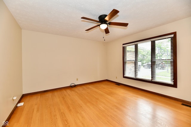 12087 N Gasburg Rd, Mooresville, IN 46158 - spare room featuring light wood-style floors, a ceiling fan, and a textured ceiling
