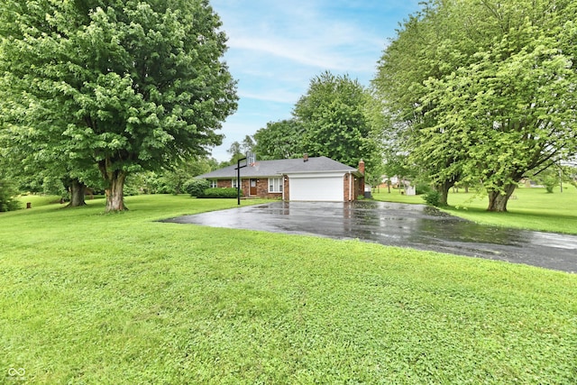 12087 N Gasburg Rd, Mooresville, IN 46158 - view of grassy yard with asphalt driveway and a garage
