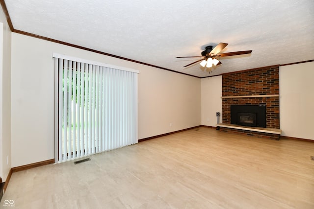 12087 N Gasburg Rd, Mooresville, IN 46158 - unfurnished living room with a ceiling fan, wood finished floors, a brick fireplace, crown molding, and a textured ceiling