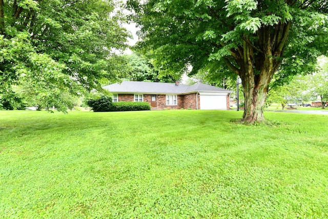 12087 N Gasburg Rd, Mooresville, IN 46158 - single story home with an attached garage, a front yard, a chimney, and brick siding