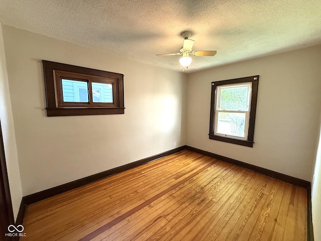 324 E Southern Ave, Indianapolis, IN 46225 - spare room featuring light wood finished floors, baseboards, a textured ceiling, and ceiling fan