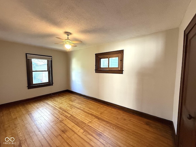 324 E Southern Ave, Indianapolis, IN 46225 - empty room with baseboards, a textured ceiling, light wood finished floors, and a ceiling fan