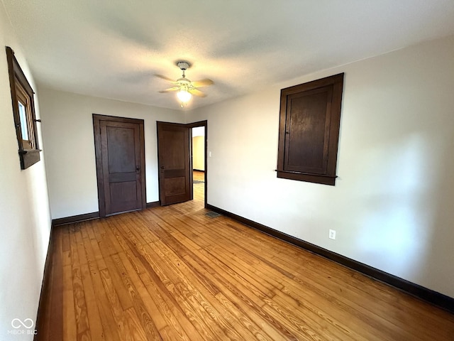324 E Southern Ave, Indianapolis, IN 46225 - unfurnished bedroom with baseboards, light wood-style flooring, and a ceiling fan