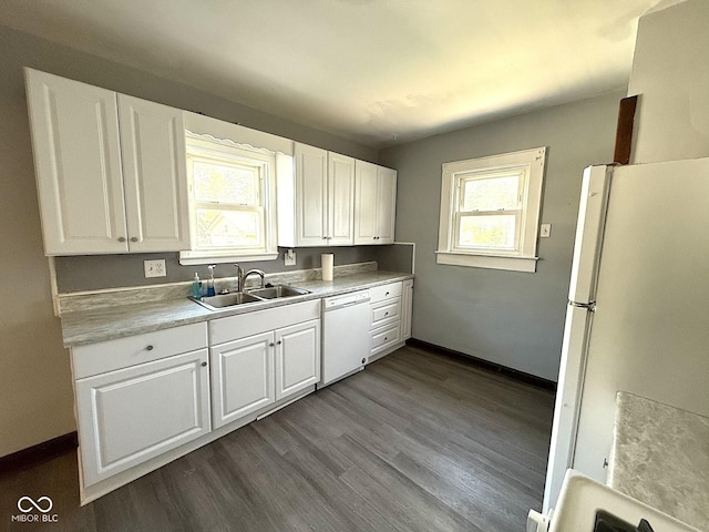 324 E Southern Ave, Indianapolis, IN 46225 - kitchen featuring white appliances, a sink, white cabinets, dark wood-style floors, and baseboards