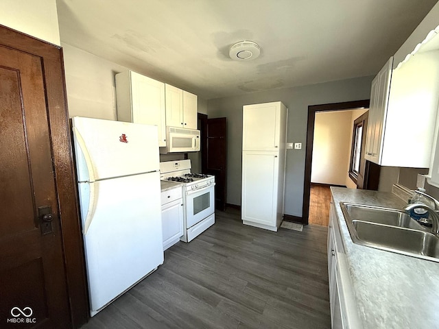 324 E Southern Ave, Indianapolis, IN 46225 - kitchen featuring white appliances, a sink, white cabinetry, and dark wood-style floors