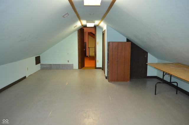 931 Beech Dr, Greenwood, IN 46142 - bonus room featuring baseboards, concrete flooring, and lofted ceiling