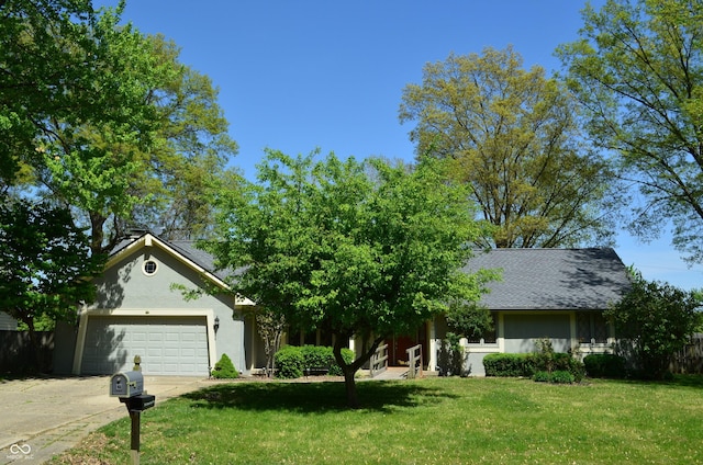 931 Beech Dr, Greenwood, IN 46142 - view of front of property featuring a garage, stucco siding, driveway, and a front yard